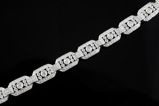 An Art Deco style 18ct white gold and diamond set octagonal link bracelet, 18.5cm.